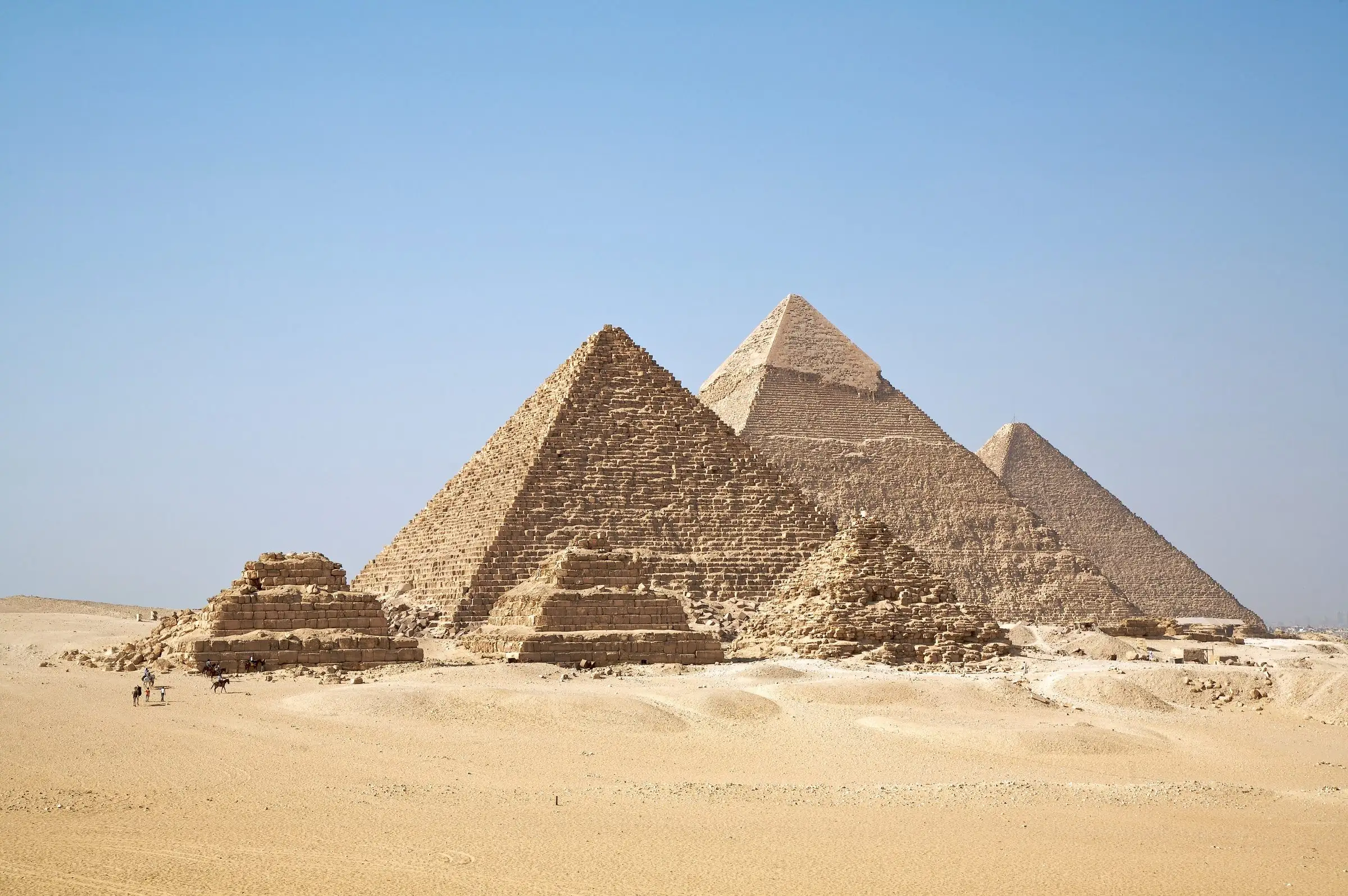 The pyramids of Giza in the desert under a clear sky