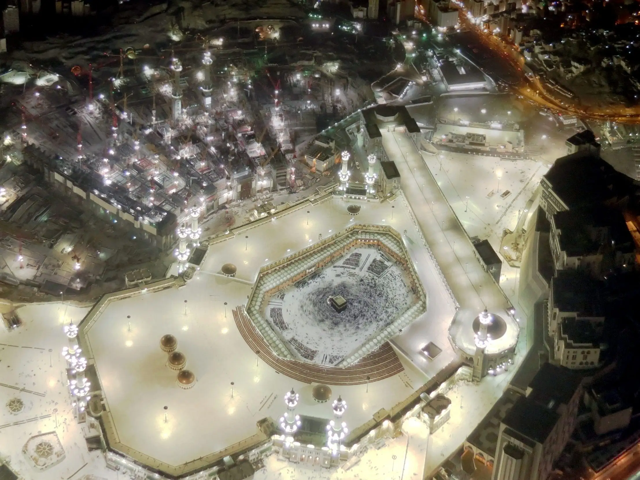 Masjid al-Haram seen from above at night, brightly lit