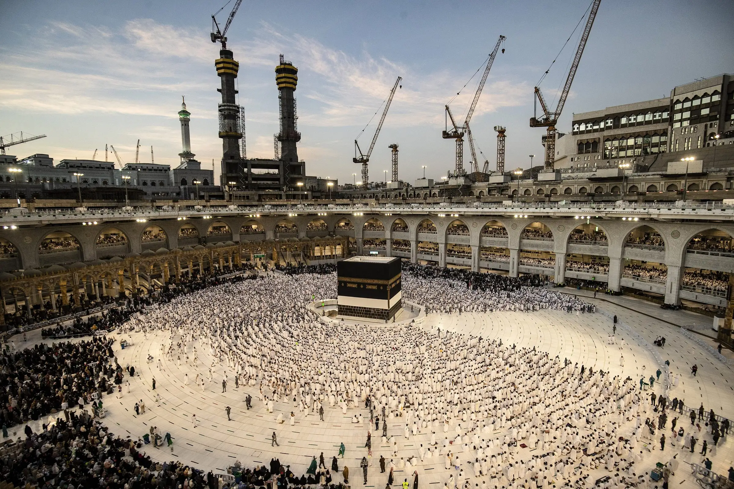 Pilgrims around the Kaaba in the courtyard of Masjid al-Haram, Makkah, at dusk