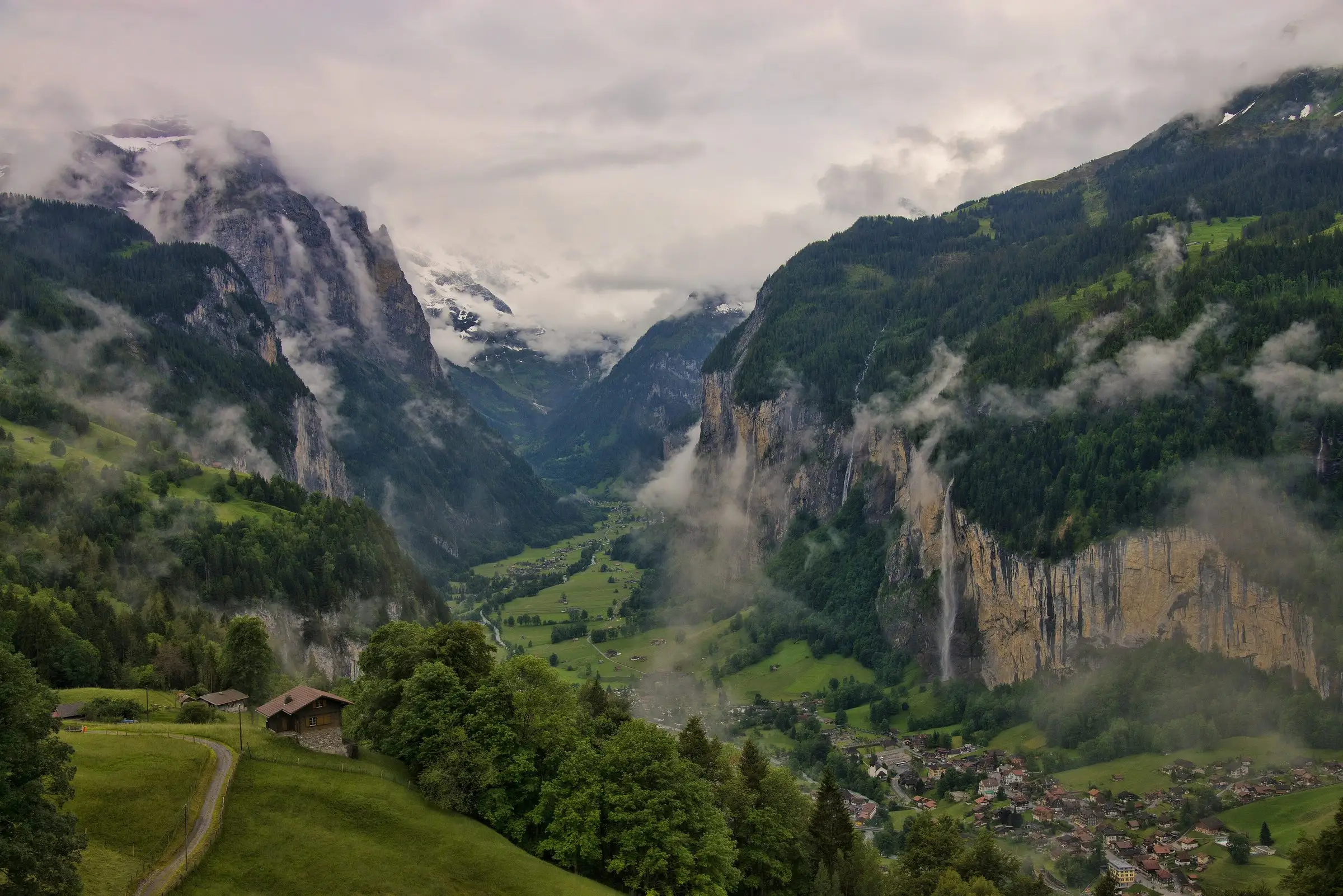 The Lauterbrunnen valley with cliffs, waterfalls and low clouds