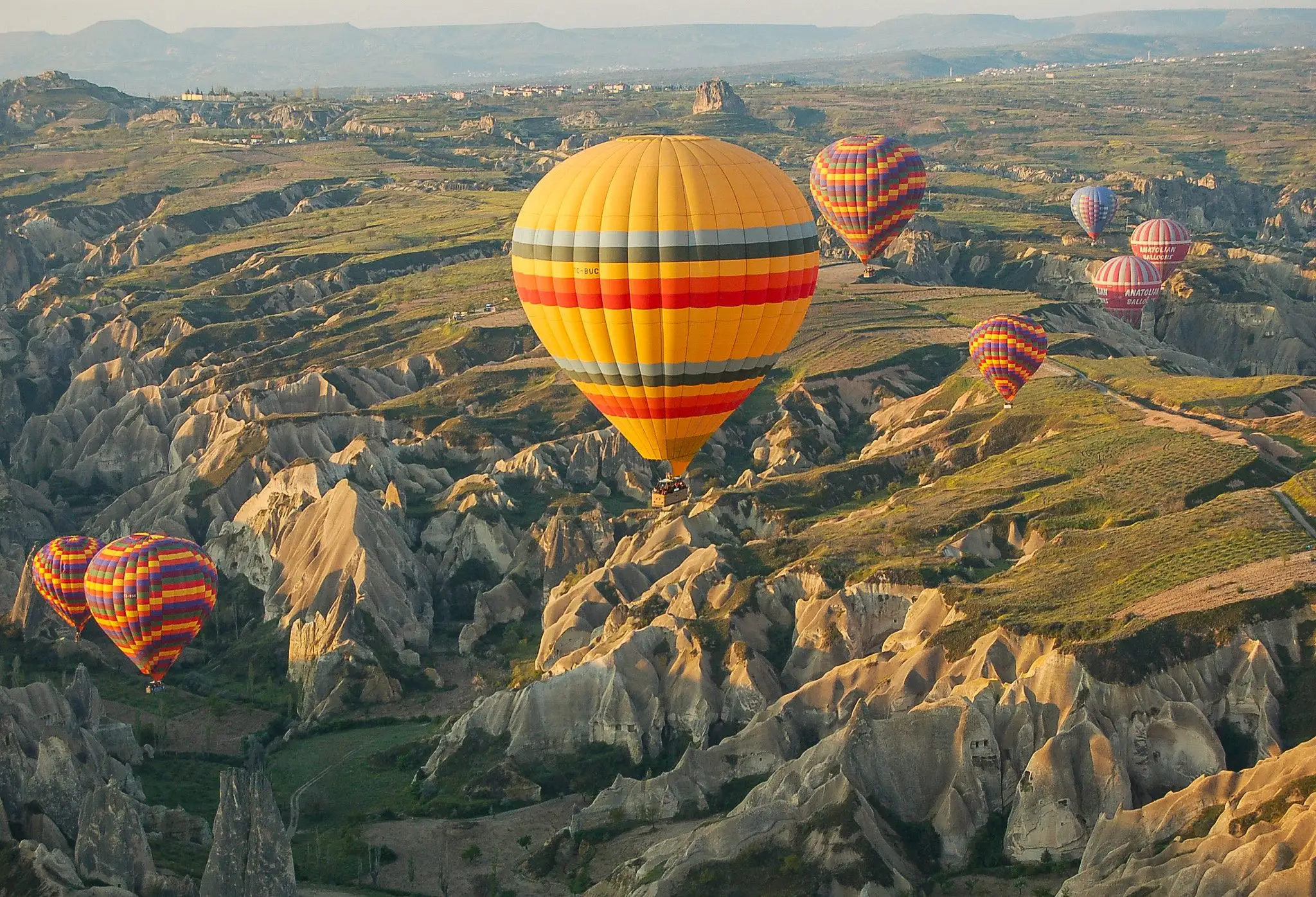 Hot air balloons floating over the valleys of Cappadocia