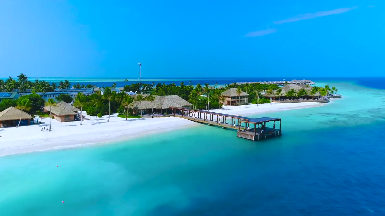 Aerial view of a Maldives island resort in turquoise water