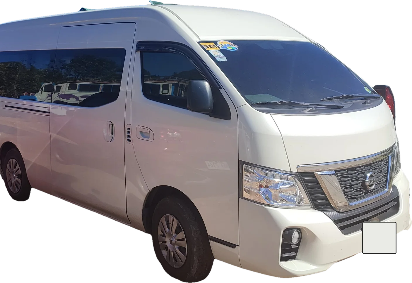 A white Nissan Urvan van, front three-quarter view