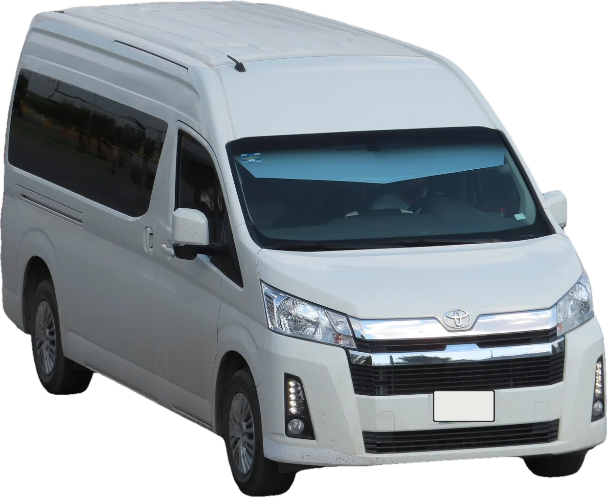 A white high-roof Toyota HiAce van, front three-quarter view